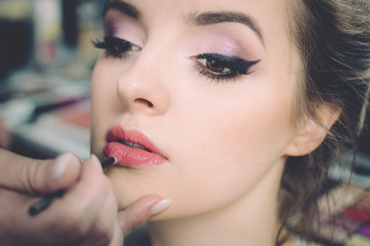 Lip color being applied with care